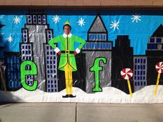 a man is standing in front of a mural