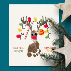 a christmas card with an image of a reindeer and candy canes on the nose