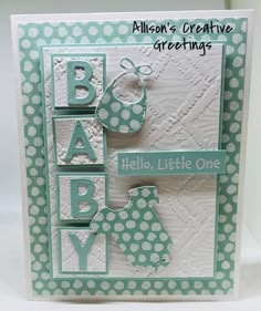 a card with the words hello little one in green and white polka dots on it