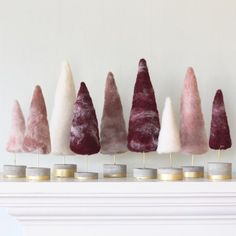 five different colored cones are lined up on top of each other in front of a fireplace