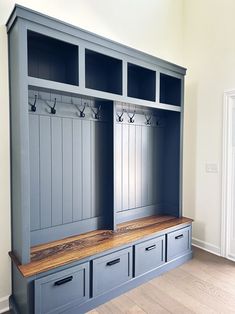 an empty room with two benches and some drawers on the wall next to each other