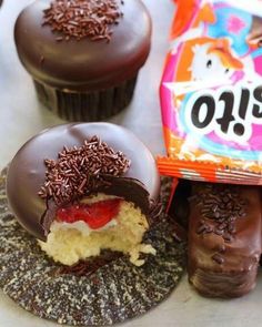 chocolate covered donuts with sprinkles and a bag of oreo cookies