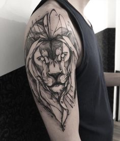 a man with a lion tattoo on his arm