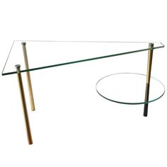 a glass table with two metal poles on it