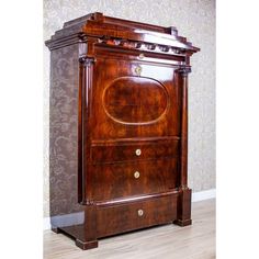 an old fashioned wooden cabinet in a room