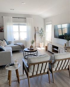 a living room filled with furniture and a flat screen tv