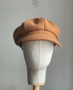 a brown hat is sitting on top of a mannequin head