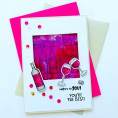 two greeting cards with wine bottles and confetti on them