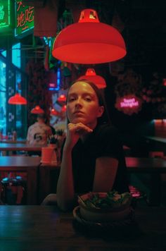 a woman sitting at a table in a restaurant