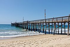 a long pier stretches out into the ocean