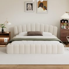 a white bed sitting in a bedroom on top of a hard wood floor