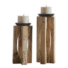 two wooden candle holders with white candles on them