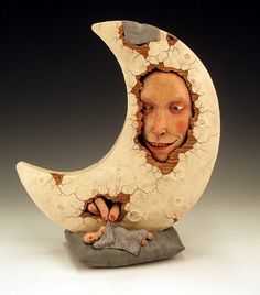 a ceramic sculpture of a man on the moon