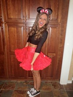 a woman in minnie mouse costume posing for the camera