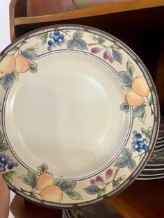 an empty plate sitting on top of a wooden shelf