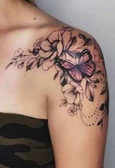 a woman's shoulder with flowers and a butterfly on it