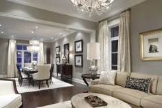 a living room filled with furniture and a chandelier