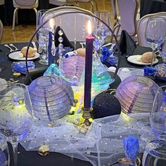 the table is set with purple and blue decorations