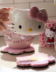 a hello kitty coffee cup on a coaster