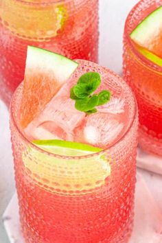 three glasses filled with watermelon and limeade on top of a white table