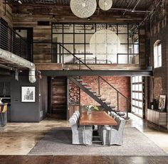 an industrial loft with exposed brick walls and wood flooring is pictured in this image