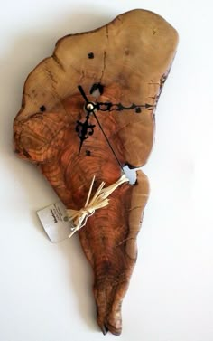 a clock made out of a piece of wood