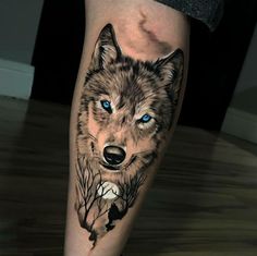 a wolf tattoo on the leg with blue eyes and trees in the foregrounds