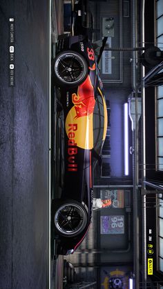 a red bull racing car hanging from the ceiling