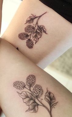 two tattoos on the legs of women with flowers and leaves tattooed on each side of their thighs