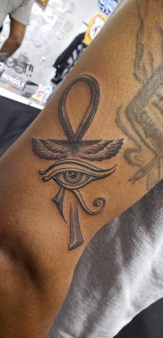 a man with a tattoo on his arm and an eye in the middle of it