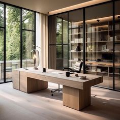 an office with glass walls and large windows overlooking the trees in the backround