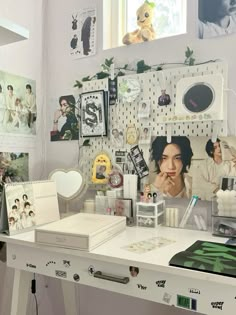 a white desk topped with pictures and other items