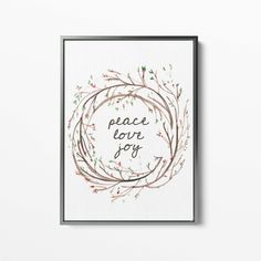 a framed print with the words peace love joy in a circle surrounded by branches and berries