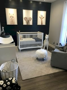 a baby's room is decorated in black, white and gray with giraffes on the wall