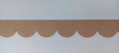 a piece of cardboard with scallops cut out on the side to make a border