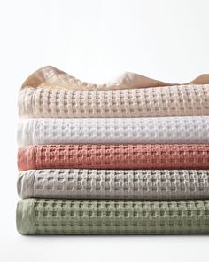 the sheets are folded neatly on top of each other in different colors and patterns,