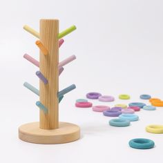 a wooden toy tree with colored circles around it