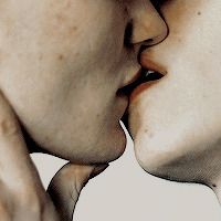 two people kissing each other with their noses close together