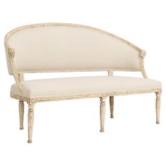 a white bench with an upholstered back and seat cushion on the bottom half