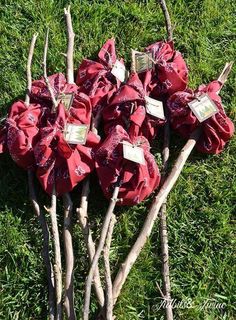 there are many branches that have been wrapped in red cloth and tied together with tags on them