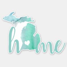 the michigan state shape cut out from watercolor paper with the word home on it