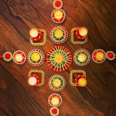 decorated diya with lit candles on wooden table