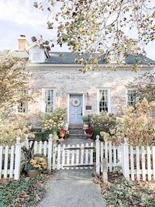 a white picket fence in front of a house