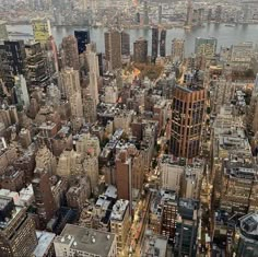 an aerial view of new york city with the empire building in the foreground and other tall buildings