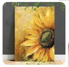 a painting of a sunflower on a wall next to a vase with flowers in it