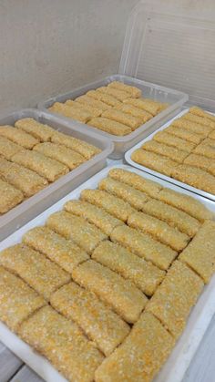 several trays filled with food sitting on top of a table