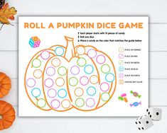 a roll a pumpkin dice game on a table