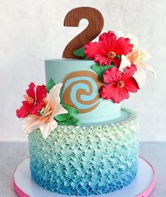 a cake decorated with flowers and the number two on top