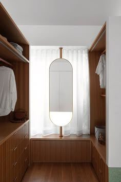 an empty dressing room with wooden cabinets and drawers