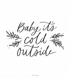 the phrase baby it's cold outside in black ink on a white dotted background